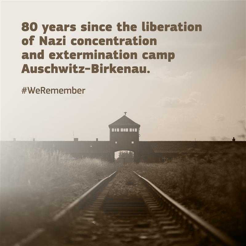 An image of the railway tracks leading to the main gate of Auschwitz-Birkenau, the Nazi concentration and extermination camp. The text reads, "80 years since the liberation of Nazi concentraition and extermination camp Auschwitz-Birkenau." Below is the hashtag #WeRemember. 